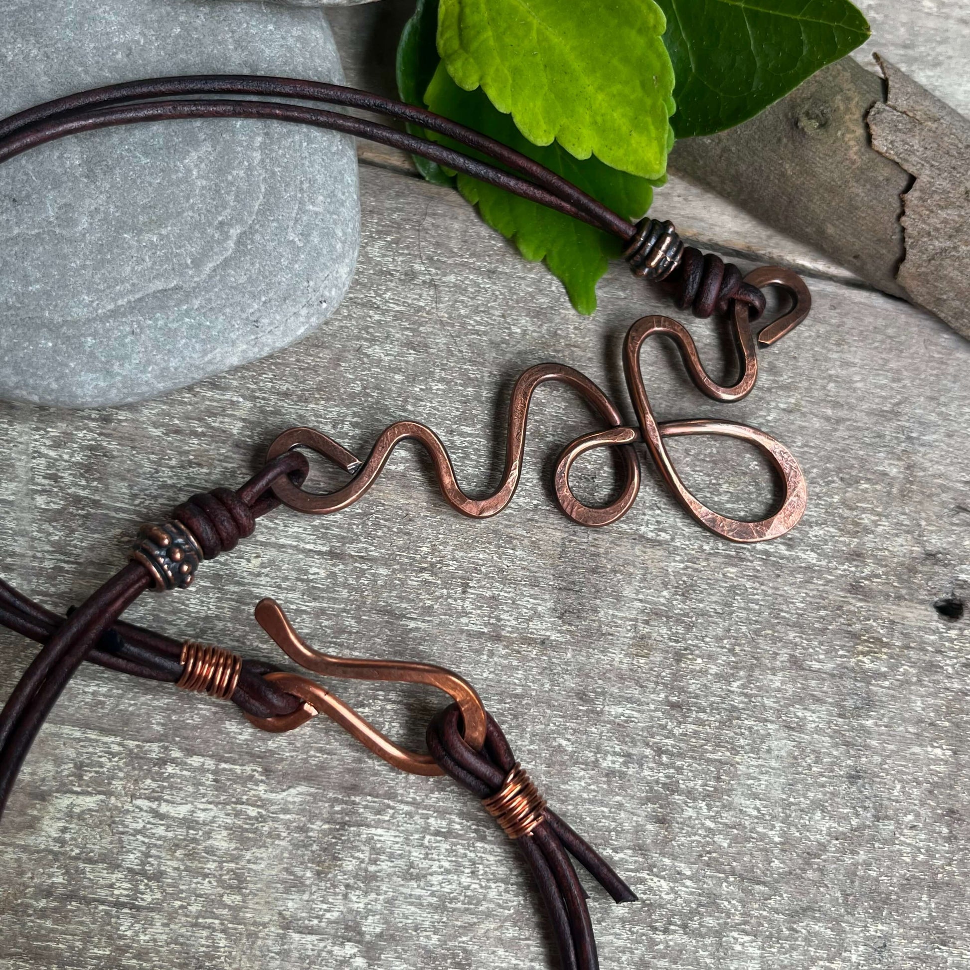 Swirl copper pendant on leather