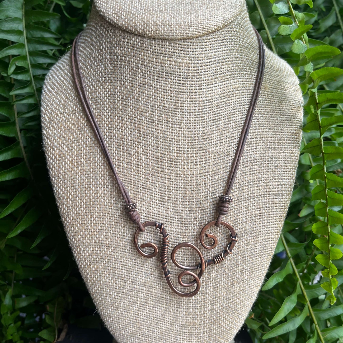 copper swirl with wire wrapping on bust