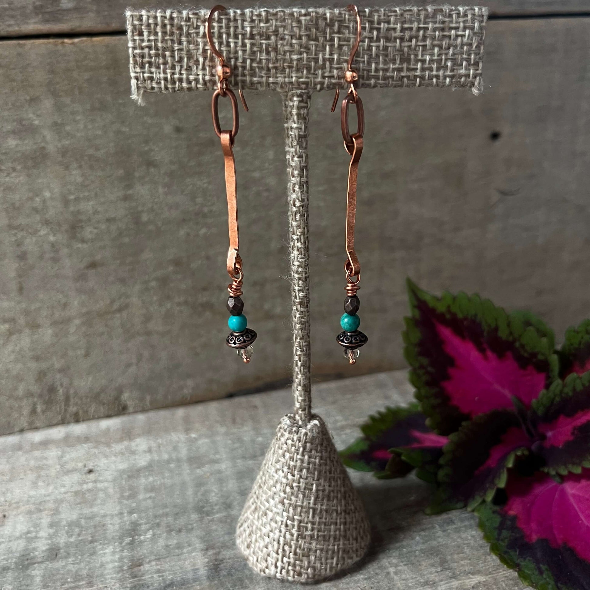 Copper dangle earrings hanging