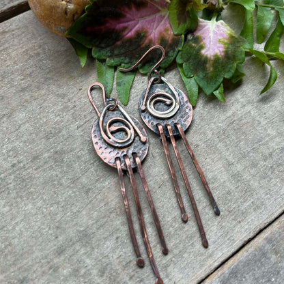 Copper fringe circle earrings on wood