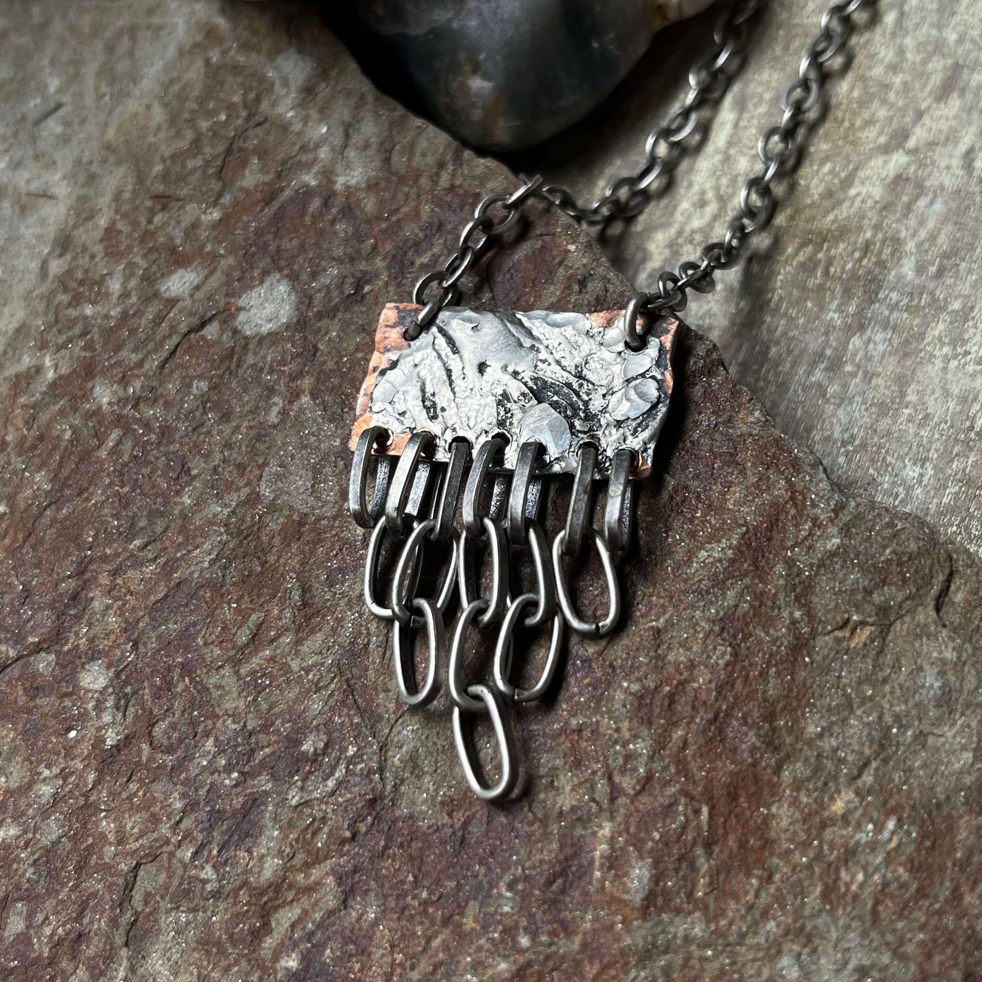 very close up mixed metal pendant