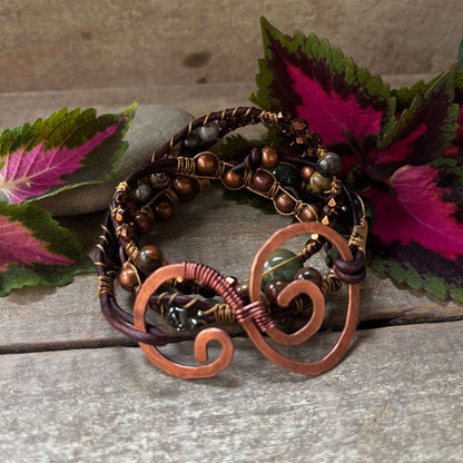 Triple Wrap Beaded Bracelet with Swirl closure  on wood with leaves