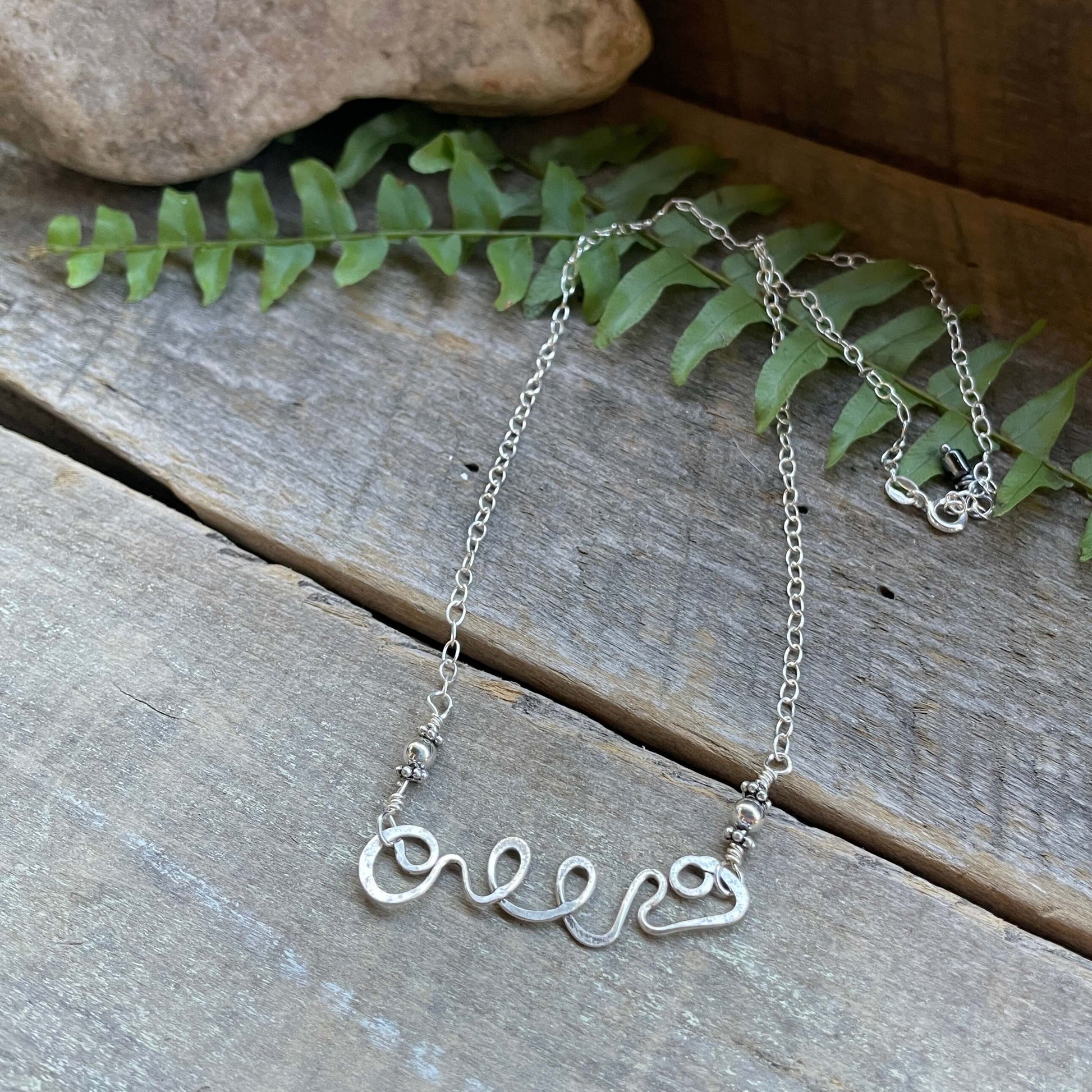 swirl necklace on wood