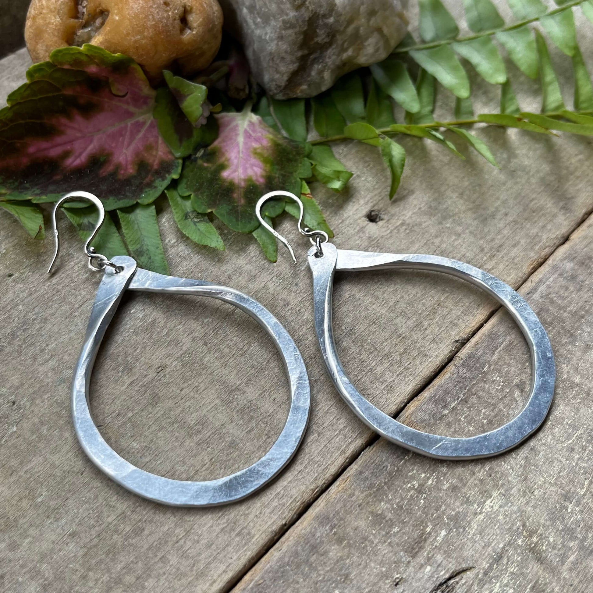 Classic Lightweight Aluminum Loop Earrings on wood with leaves